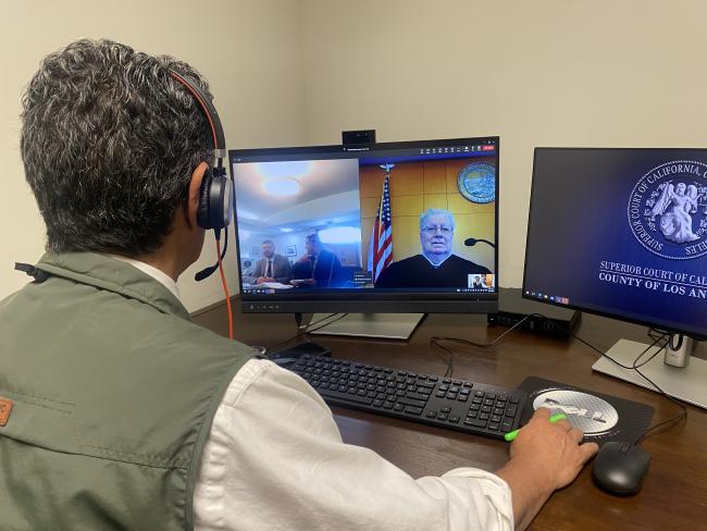 man sitting using computer equipment